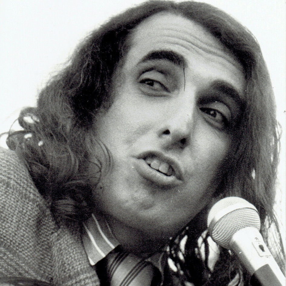 American singer and musician Tiny Tim singing into a microphone in a publicity photograph taken in 1969.