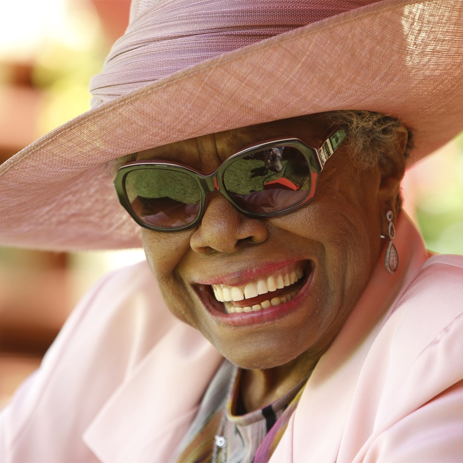 Maya Angelou smiling while wearing sunglasses and a hat